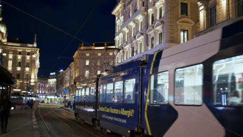 Milan, Italy – March 22, 2025: Tram passing by on the street in the evening - Starpik Stock