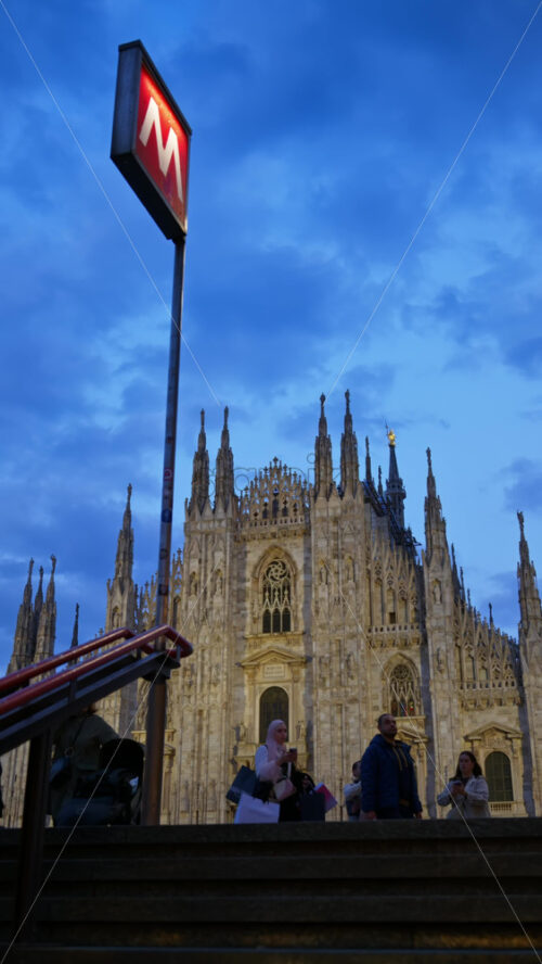 Milan, Italy – March 22, 2025: View of the Duomo from the stairs of the metro station in the evening. Vertical - Starpik Stock