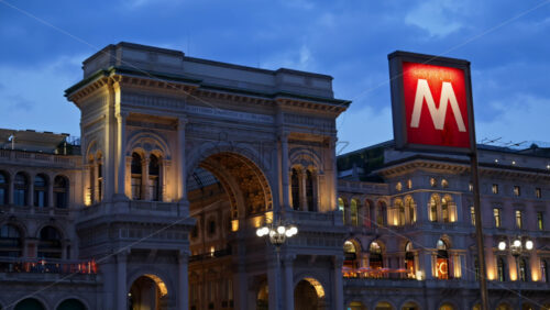 Milan, Italy – March 22, 2025: View of the Vittorio Emanuele II Gallery entrance from the Duomo square in the evening - Starpik Stock