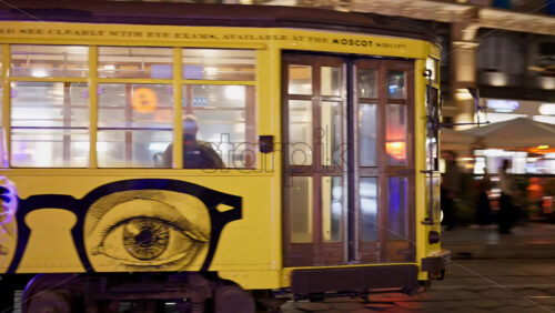 Milan, Italy – March 22, 2025: Yellow tram passing by on the street in the evening - Starpik Stock
