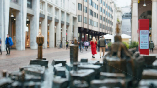 Milan, Italy – March 23, 2025: Close up of a tactile bronze city model map with people walking on the background - Starpik Stock