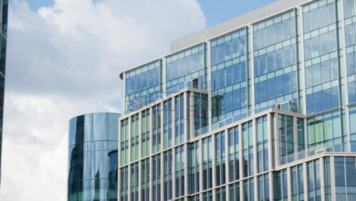 Modern glass skyscrapers of London’s financial district reflecting the blue sky next to historic architecture - Starpik Stock