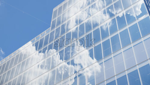 Modern glass skyscrapers of London’s financial district reflecting the blue sky next to historic architecture - Starpik Stock