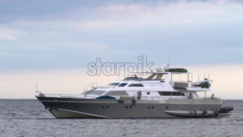 Modern motor yacht moving on calm blue water of the Mediterranean sea - Starpik Stock
