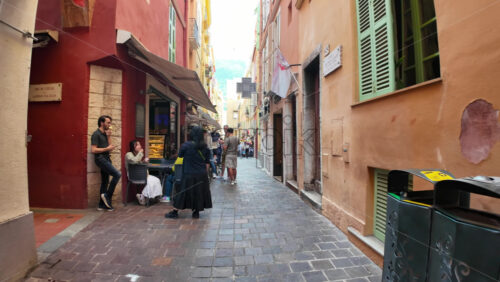 Monaco City, Monaco – July 18, 2025: Tourists strolling along the scenic pedestrian path on a charming narrow street in the city - Starpik Stock