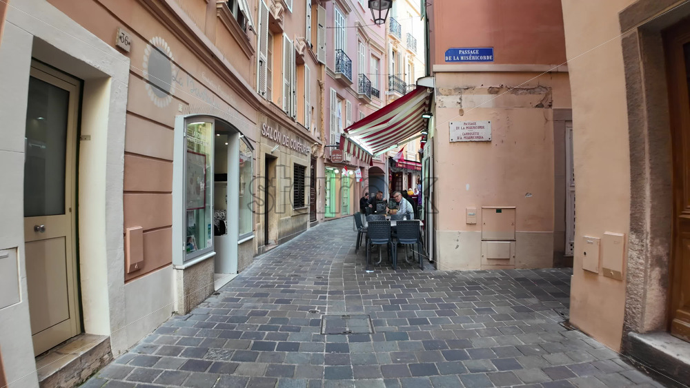 Monaco City, Monaco – July 18, 2025: Tourists strolling along the scenic pedestrian path on a charming narrow street in the city with boutiques - Starpik Stock