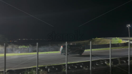 Mures, Romania – July 19, 2025: A drift car balancing on two wheels while sparks and fireworks light up the scene opening up the RoDrift competition - Starpik Stock