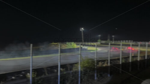Mures, Romania – July 19, 2025: Two cars drifting at high speed on the Transilvania Motor Ring, race track at night, with headlights and tire smoke at the RoDrift competition - Starpik Stock
