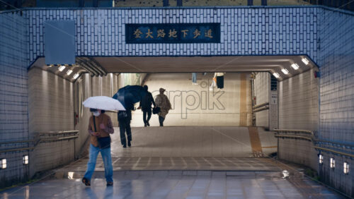 Nara, Japan – April 10, 2025: People walking through an underground walkway to reach the Todaiji Temple. Translation: “Noborioji underground walkway” - Starpik Stock