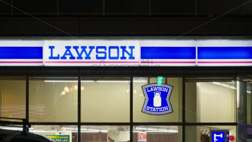 Nara, Japan – April 10, 2025: The front window of the Lawson station convenience store in the evening - Starpik Stock
