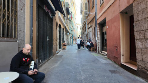 Nice, France – August 15 2025: Narrow old town street with colourful buildings, people walking, and relaxed atmosphere - Starpik Stock