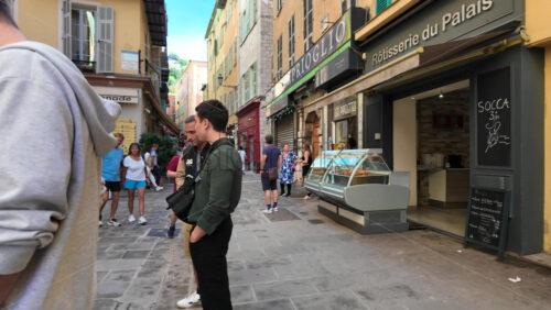 Nice, France – August 15 2025: Narrow old town street with colourful buildings, people walking, and relaxed atmosphere - Starpik Stock