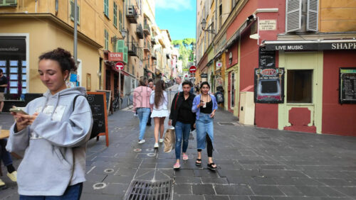 Nice, France – August 15 2025: Pedestrian street lined with shops and restaurants, including people dining outdoors - Starpik Stock