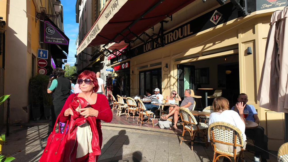 Nice, France – August 15 2025: Pedestrian street lined with shops and restaurants, including people dining outdoors - Starpik Stock