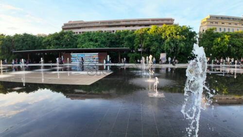 Nice, France – August 15, 2025: People walking through the Promenade du Paillon park near a water fountain in daylight - Starpik Stock