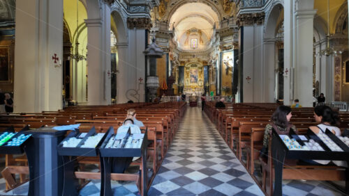 Nice, France – August 15 2025: View of the inside of the Saint James the Greater Church with detailed architecture, high arches, and people sitting in pews - Starpik Stock