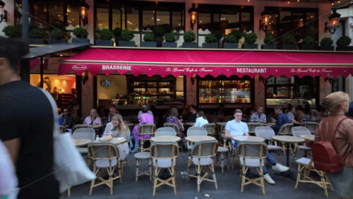 Nice, France – July 20, 2025: Busy evening scene at a French brasserie with outdoor terrace seating - Starpik Stock