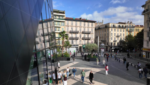Nice, France – July 20, 2025: Hugh angle view of people walking through a square of the city on a sunny day - Starpik Stock