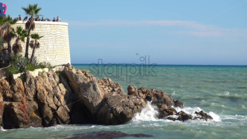 Nice, France – July 3, 2025: View of the I Love Nice sign on the Promenade des Anglais, with tourists enjoying the lookout and a passenger boat cruising across the Mediterranean Sea - Starpik Stock