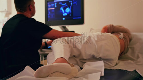 Pregnant woman undergoing an ultrasonography at a doctor’s office - Starpik Stock