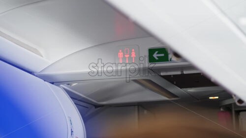 Red, occupied toilet sign on an airplane - Starpik Stock