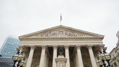 Royal Exchange building with surrounding skyscrapers in London, England - Starpik Stock