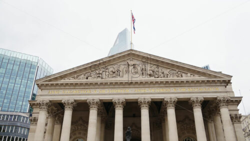 Royal Exchange building with surrounding skyscrapers in London, England - Starpik Stock