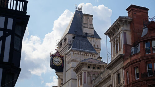 Street view of the clock tower and of the Royal Courts of Justice in London, England - Starpik Stock