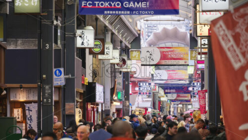Taito, Japan – April 13. 2025: People walking through the Asakusa, Kannon Dori Market in daylight. Translation: “Store names” - Starpik Stock
