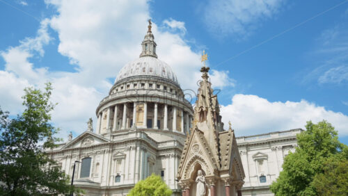 The Dome of St. Paul’s Cathedral rising above the trees with a clear blue sky in the background in London, England - Starpik Stock