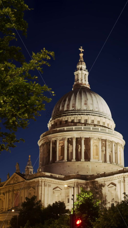 The Dome of St. Paul’s Cathedral rising above the trees with the night sky in the background in London, England. Vertical - Starpik Stock