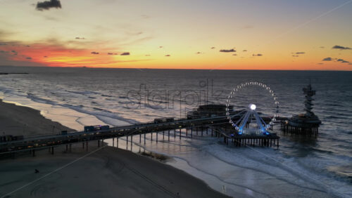 The Hague, Netherlands – November 21, 2024: Aerial drone view of the Scheveningen Pier and Ferris Wheel at the Dutch North Sea Coast - Starpik Stock