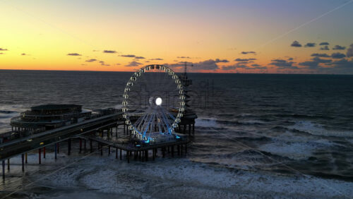 The Hague, Netherlands – November 21, 2024: Aerial drone view of the Scheveningen Pier and Ferris Wheel at the Dutch North Sea Coast - Starpik Stock