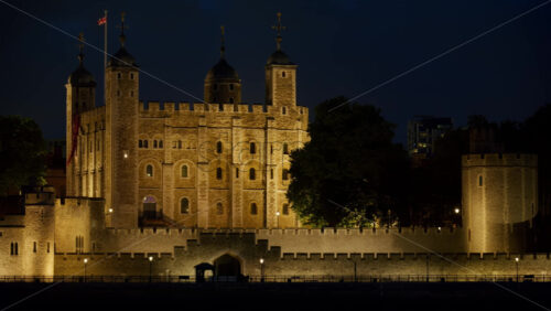 The Tower of London walls lit up warmly in the evening in England - Starpik Stock