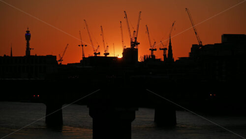 Time lapse of a train moving on Cannon Street Railway Bridge over the Thames River at sunset, London, England - Starpik Stock