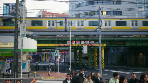 Tokyo, Japan – April 12, 2025: People, cars and public transportation moving on the streets of the city in daylight. Translation: “Limit height” - Starpik Stock