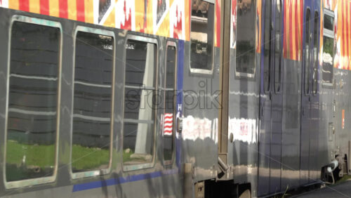 Vallauris, France – July 6, 2025: Train moving through Golfe-Juan station on a sunny day - Starpik Stock