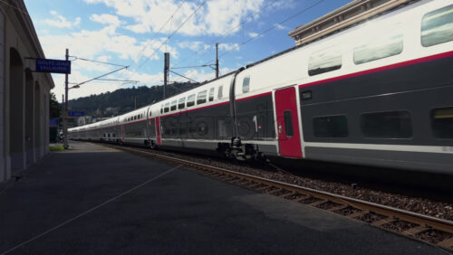 Vallauris, France – July 6, 2025: Train speeding through Golfe-Juan station on a sunny day - Starpik Stock