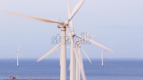 Video – Aerial drone view of offshore wind turbines spinning in the sea at the Oresund Wind Farm in Copenhagen, Denmark - Starpik Stock