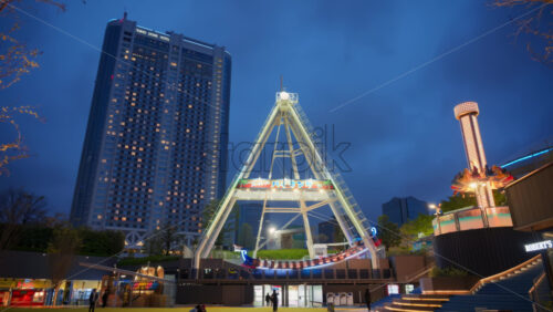 Video - Bunkyo, Japan - April 13, 2025: View of the Tokyo Dome City Attractions at the Amusement park in the evening