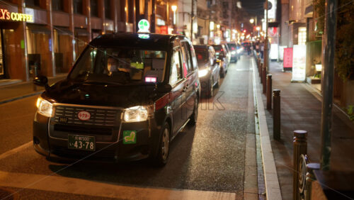 Video - Kyoto, Japan - April 11, 2025: Taxi waiting on the street in the Gion area in the evening. Translation: "Kyoto, car brand"