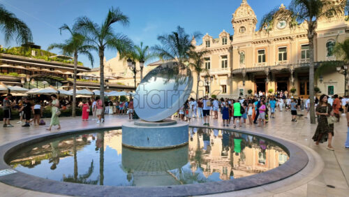 Video – Monte Carlo, Monaco – October 4, 2024: Sky mirror sculpture in front of The Monte Carlo Casino with people walking around it - Starpik Stock
