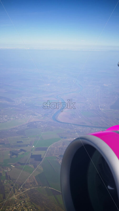 View of a turbine rotating from an airplane window. Vertical - Starpik Stock