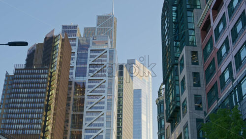 View of modern glass office buildings in the financial district of London, England with sunlight reflecting off windows - Starpik Stock