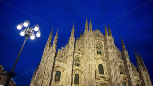 View of the Duomo in Milan, Italy in the evening with blue hour sky - Starpik Stock
