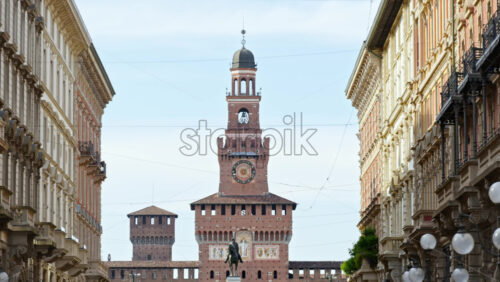 View of the Filarete Tower between buildings in Milan, Italy in daylight - Starpik Stock