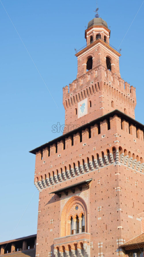 View of the Filarete Tower in Milan, Italy on the blue sky background. Vertical - Starpik Stock