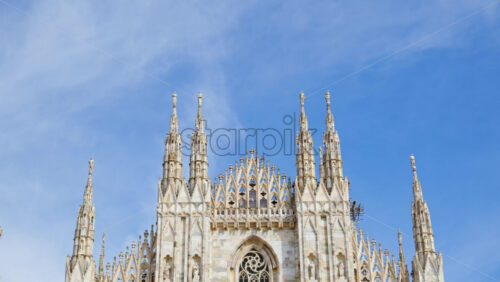 View of the Milan Cathedral in Italy over a blue sky in daylight - Starpik Stock