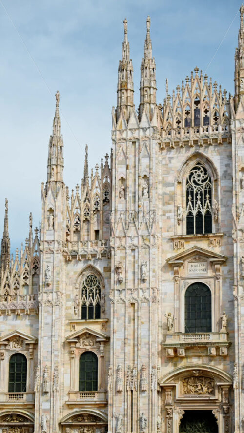 View of the Milan Cathedral in Italy over a blue sky in daylight. Vertical - Starpik Stock