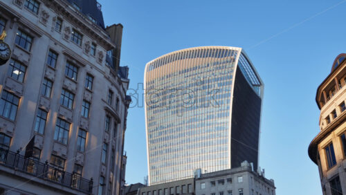 View of the Walkie-Talkie skyscraper standing tall above surrounding architecture, London, England - Starpik Stock